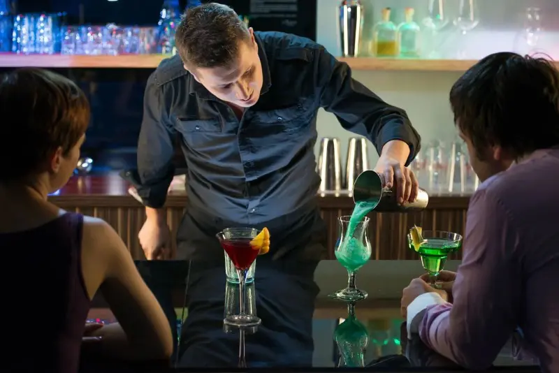 Bartender Pouring an Alcoholic Drink From the Measuring Cup